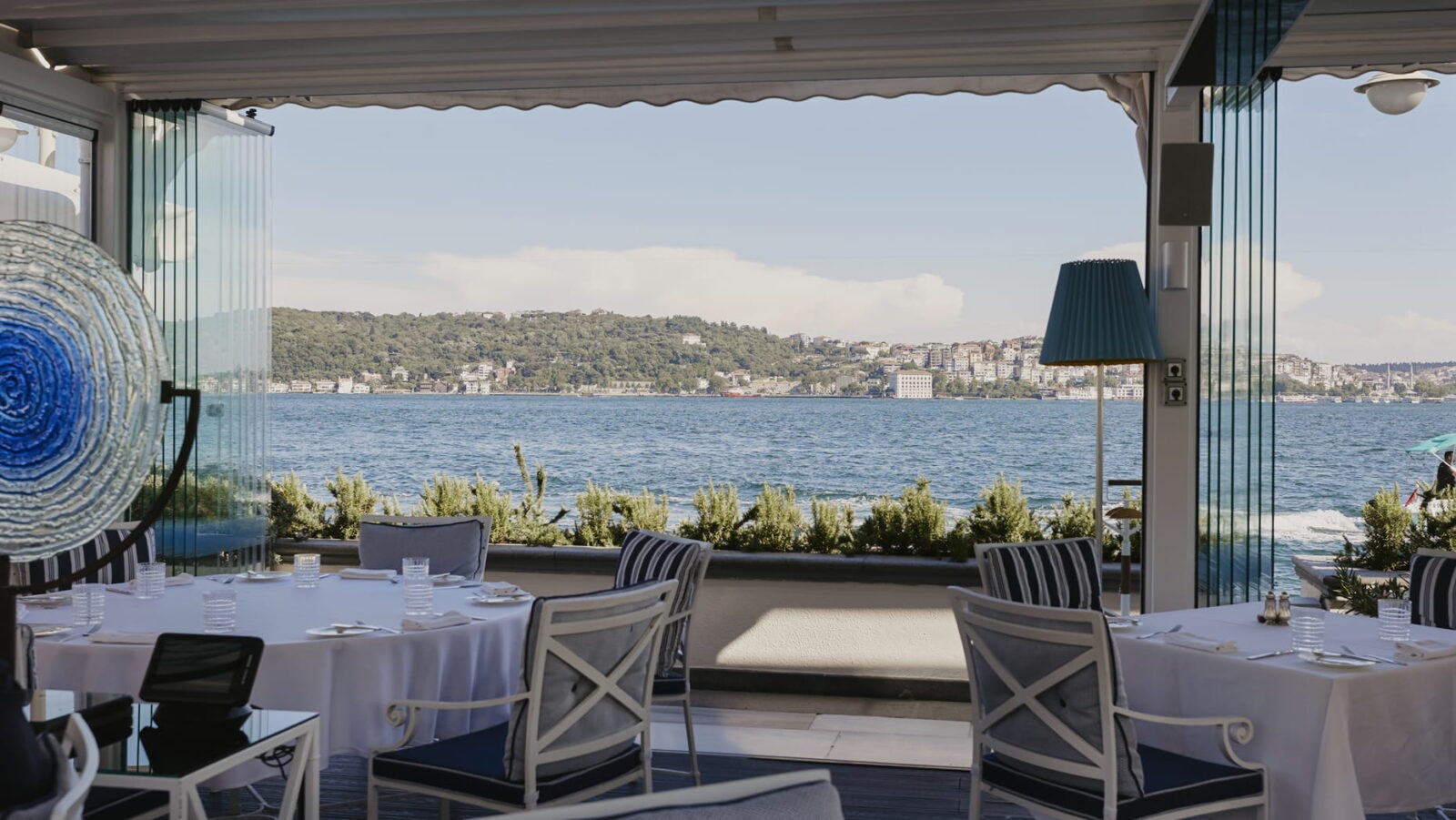 A waterfront dining area at Four Seasons Hotel Istanbul at the Bosphorus, showcasing stunning views across the Bosphorus. (Photo via Four Seasons Hotel)